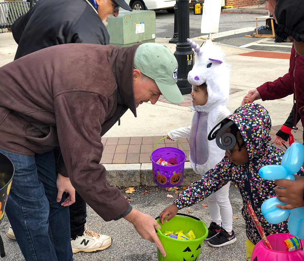 Mayor Auman and Councilman Matt Robbins give out Halloween candy to cute costumed children, October 2019.